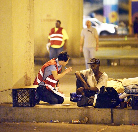 New Orleans city officials, homeless advocates and police converge under the Pontchartrain Expressway before dawn Thursday, Aug. 14, 2014 to move out the approximately 150 homeless people have been living under the bridge. Many of the people there got up and left once the crackdown started while others had to be talked to before they would vacate the encampment. 