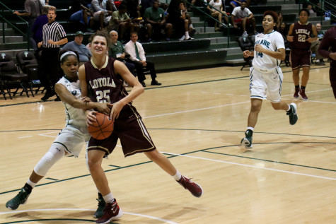 Tulane sophomore guard Kolby Morgan, left, strips the ball from Loyola freshman guard Kayla Noto on a fast break at the annual Battle of Freret, a scrimmage between the Loyola and Tulane basketball teams. On Thursday night, the women's team fell to Tulane. 
